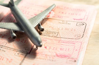 small toy airplane on a foreign passport